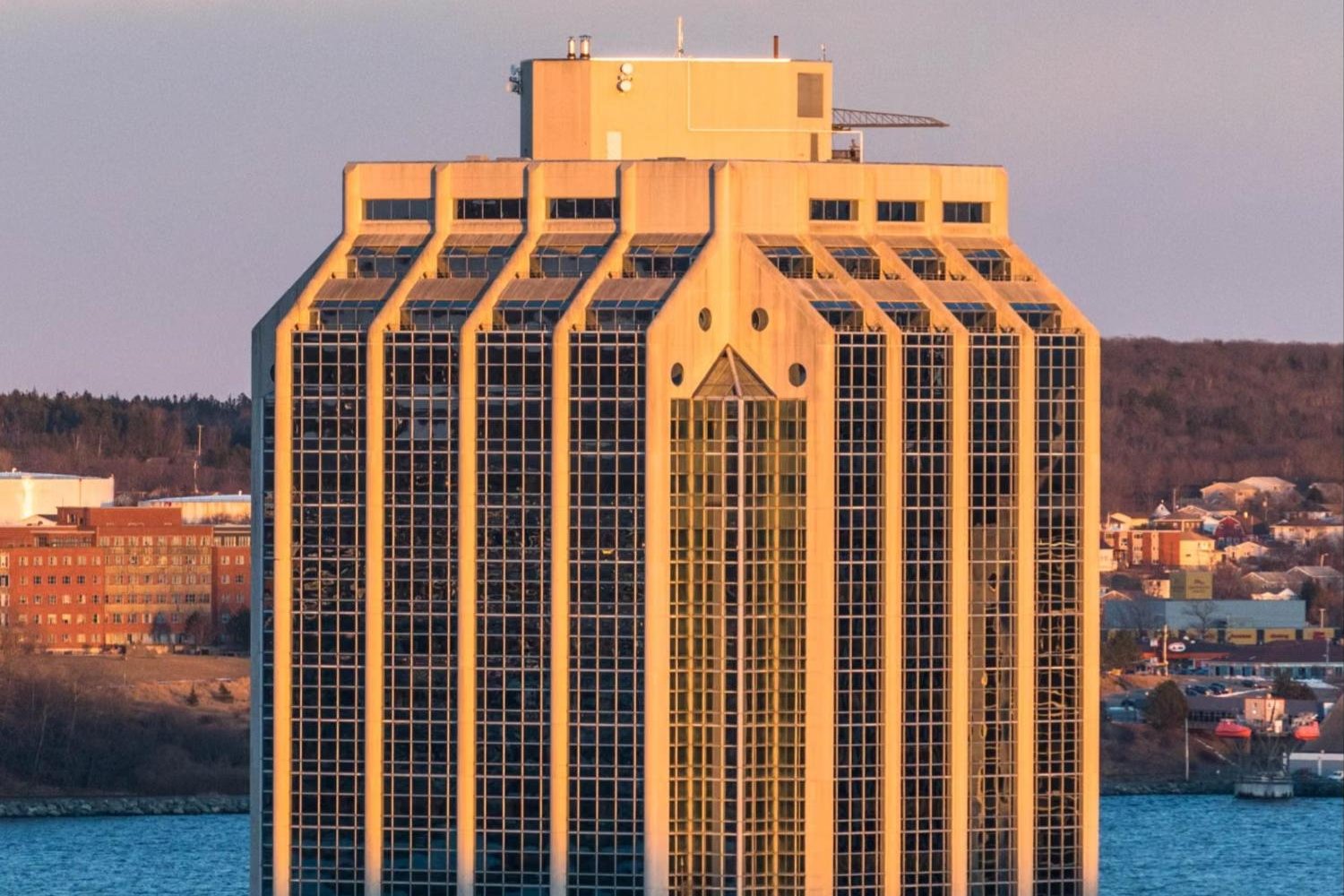 Purdy's Wharf Tower on the Halifax waterfront at sunset, with the harbour behind